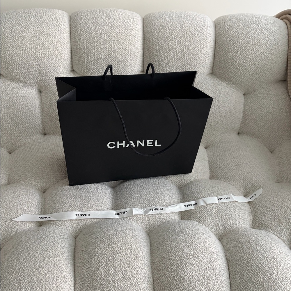 CHANEL Black Paper Bag and a Chanel White Ribbon Accent